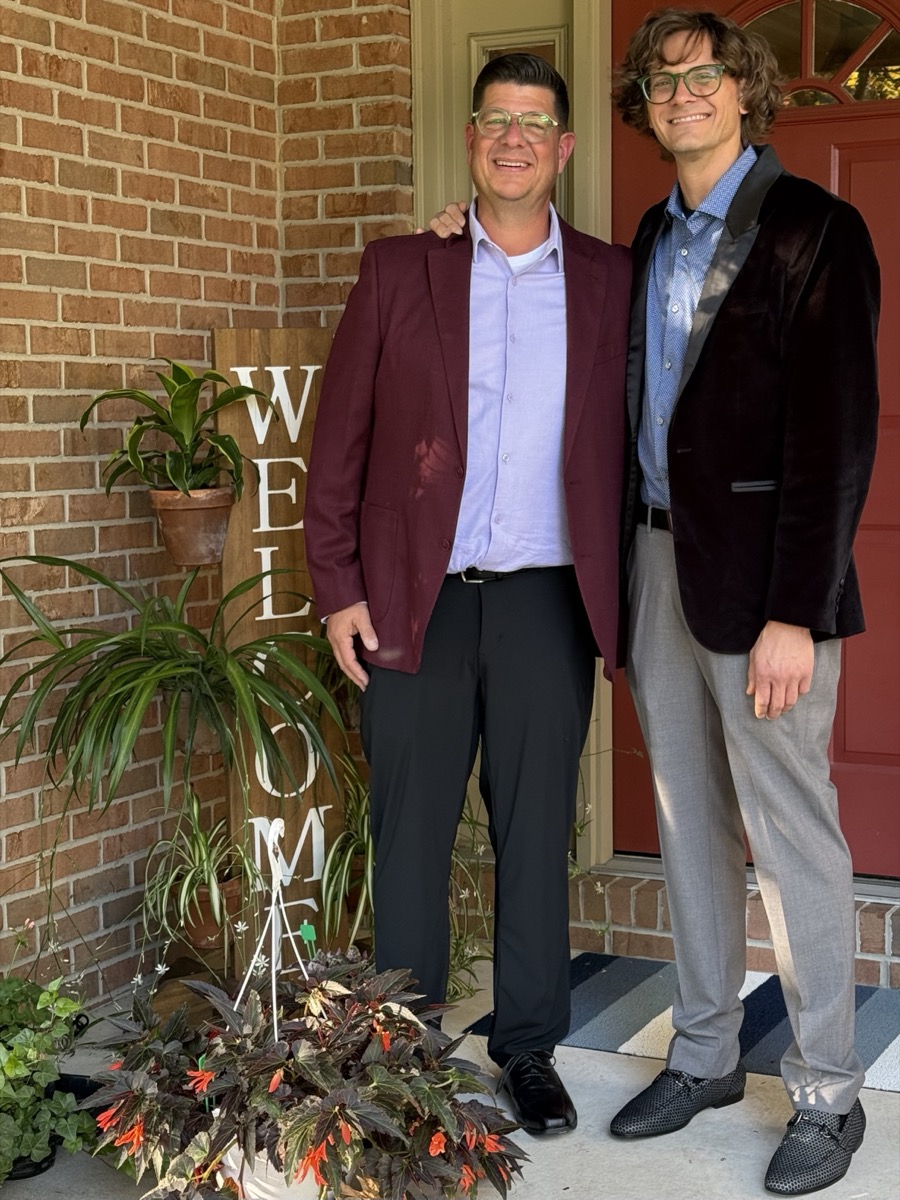 Will and Tim, co-founders of The Pot Slot, standing together on a front porch with potted plants and a welcome sign
