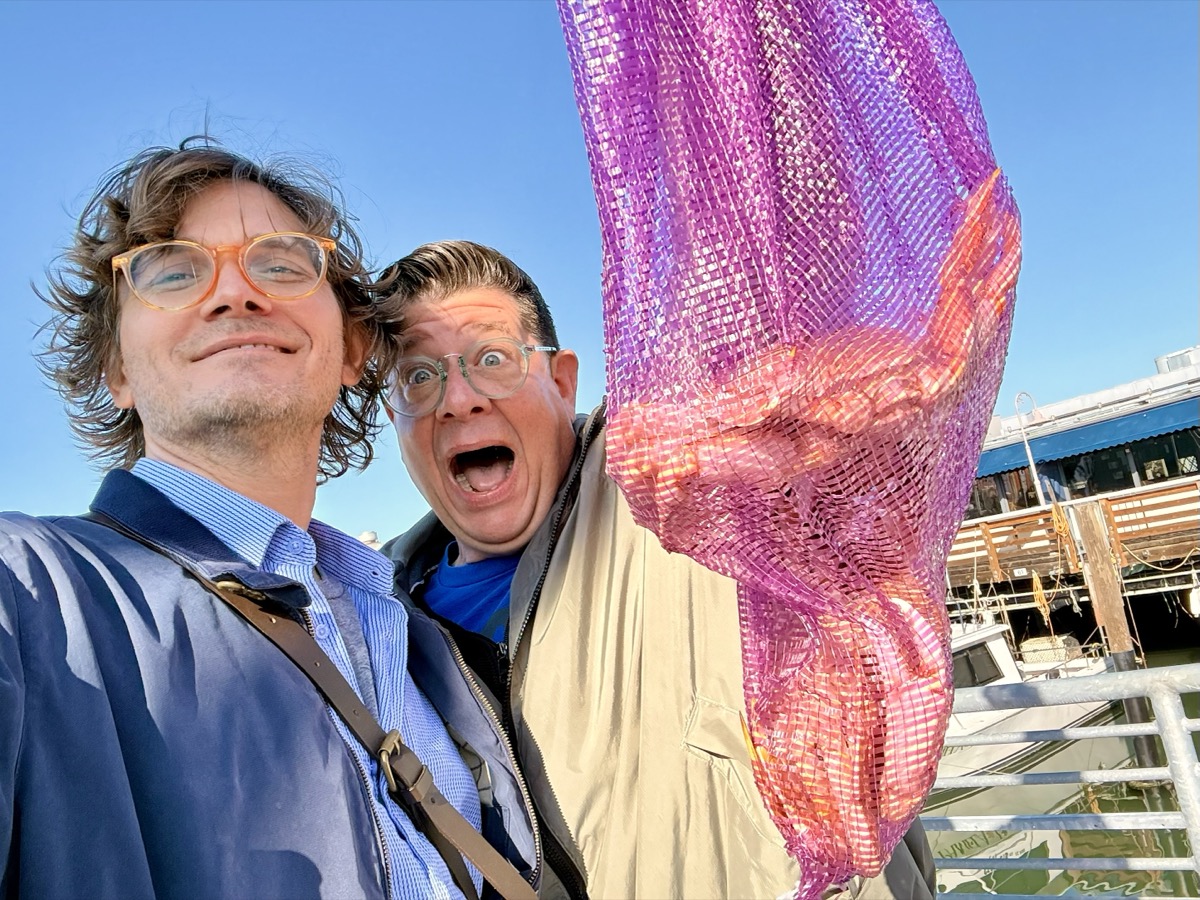 Will and Tim, co-founders of The Pot Slot, taking a fun selfie together at a waterfront dock